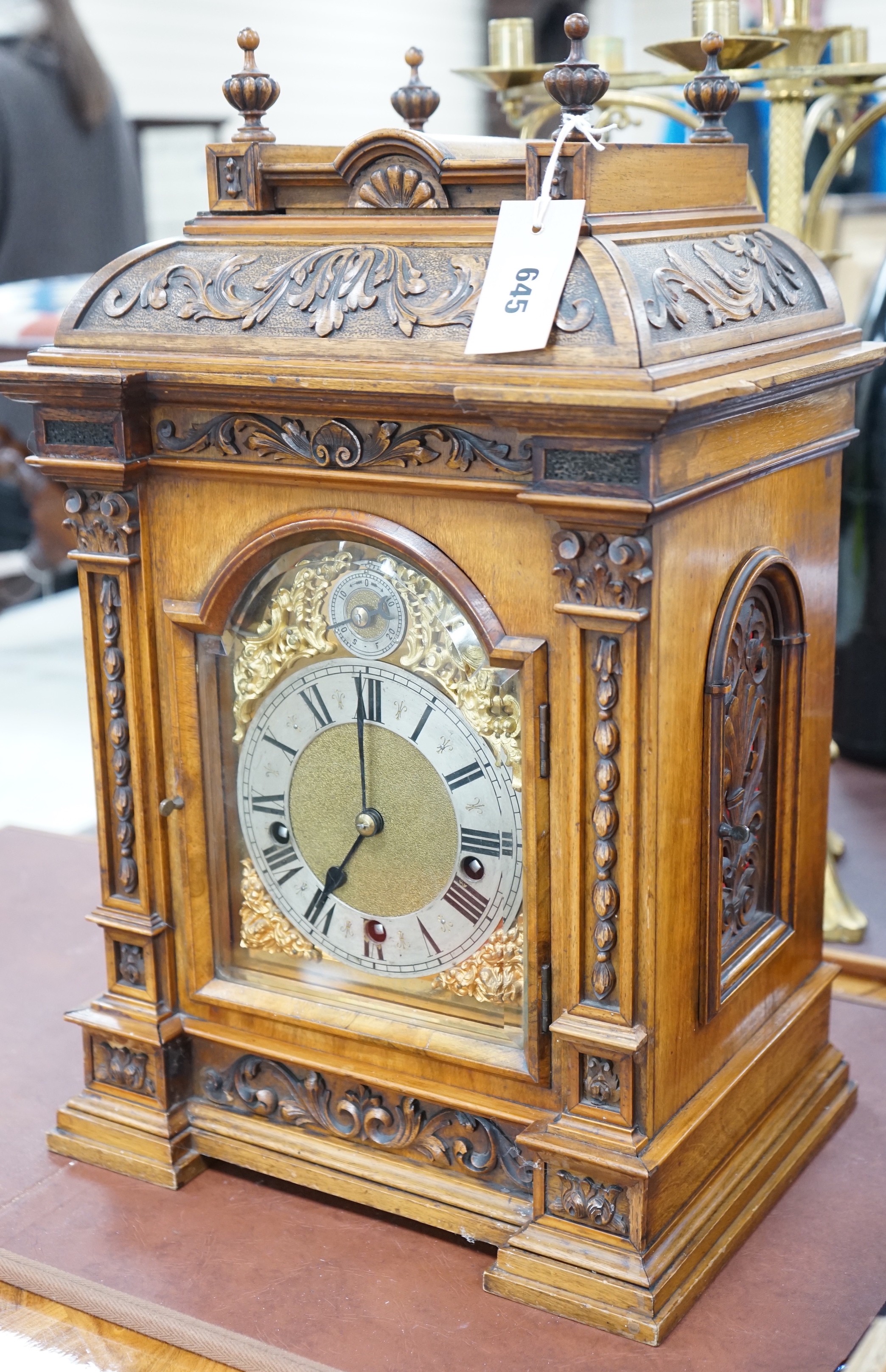 A 19th century architectural walnut bracket clock, with key and pendulum. 53cm tall